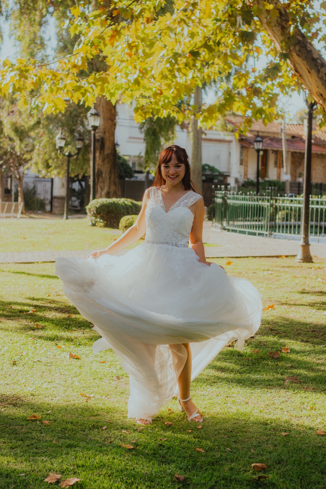 Agus twirls her dress in a park