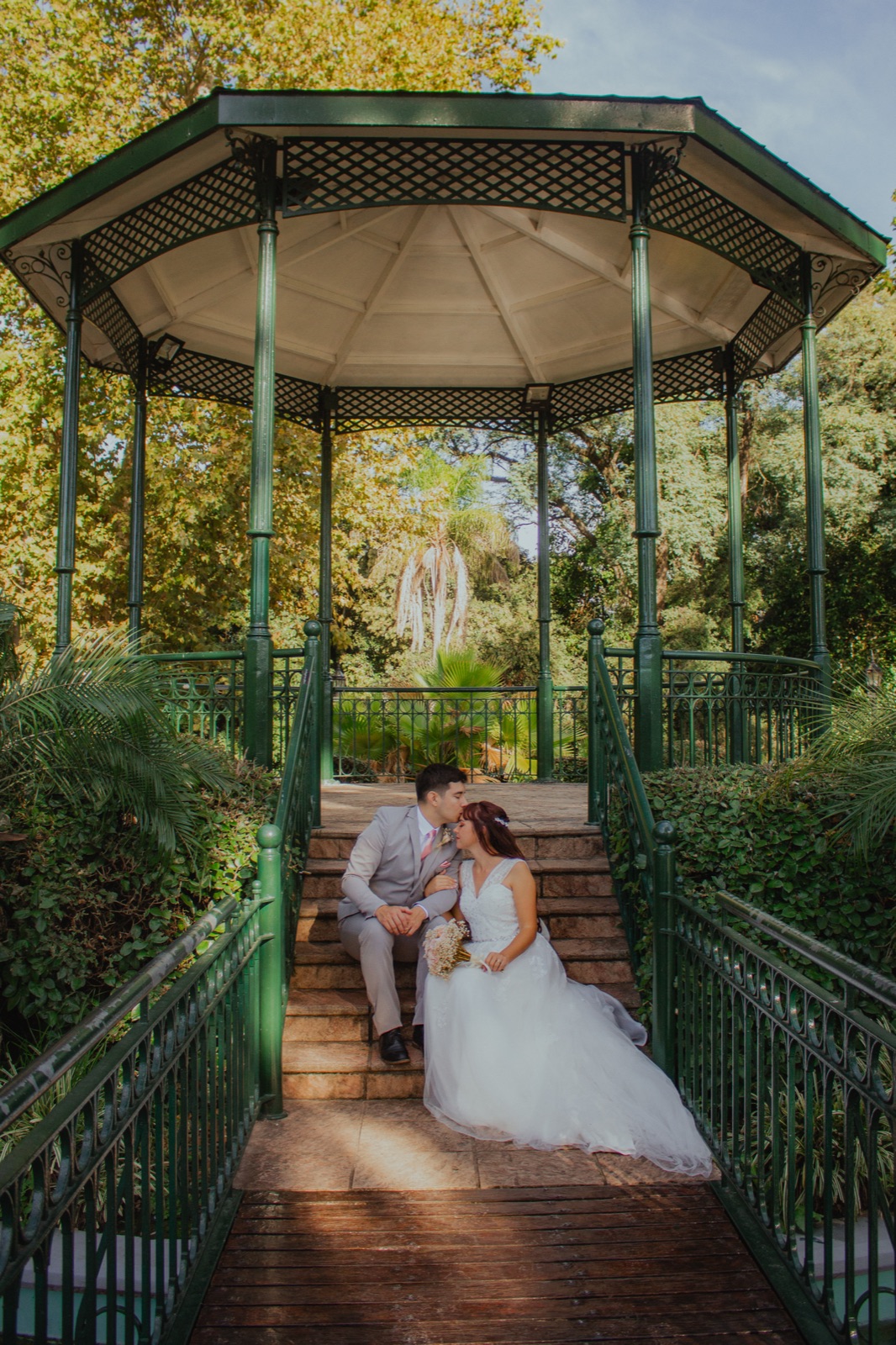 Agus and Giuliano on the steps of an iron gazebo