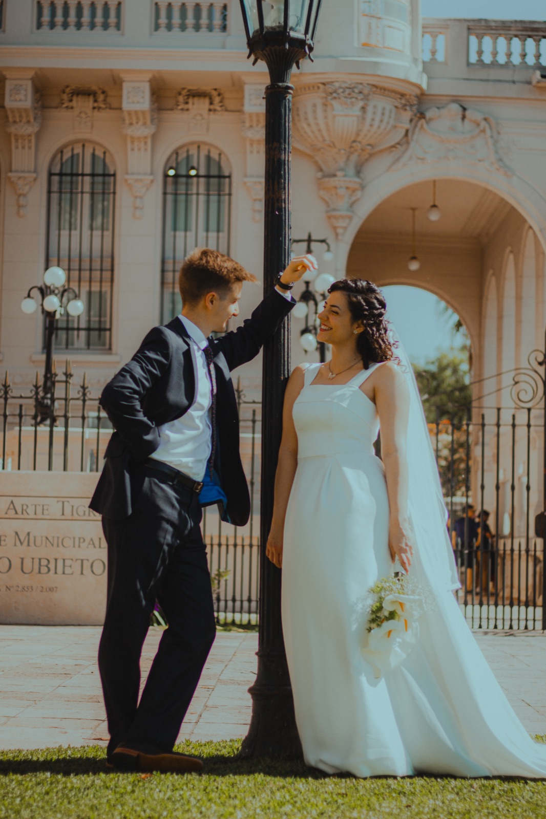 Ani and Agus by a lamppost in front of the palace