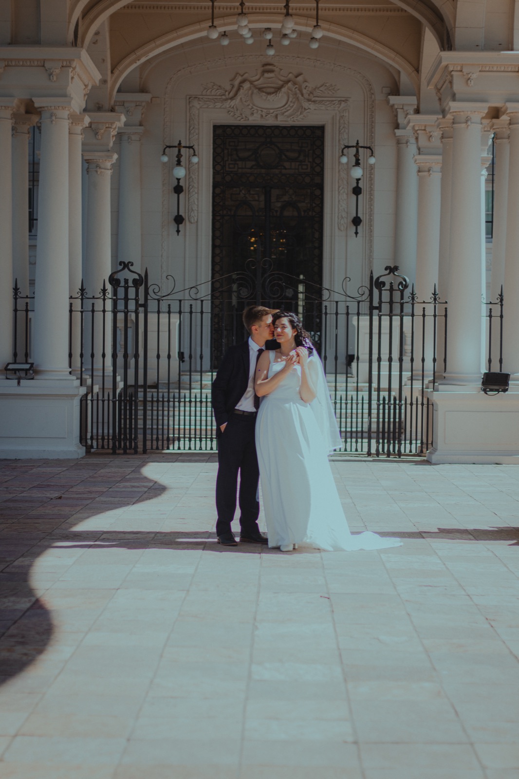 Ani and Agus at the door of a white palace