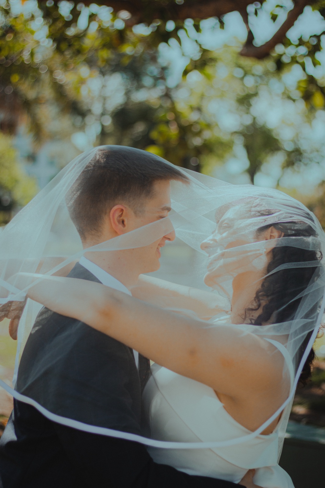 Agus holds Ani under the veil